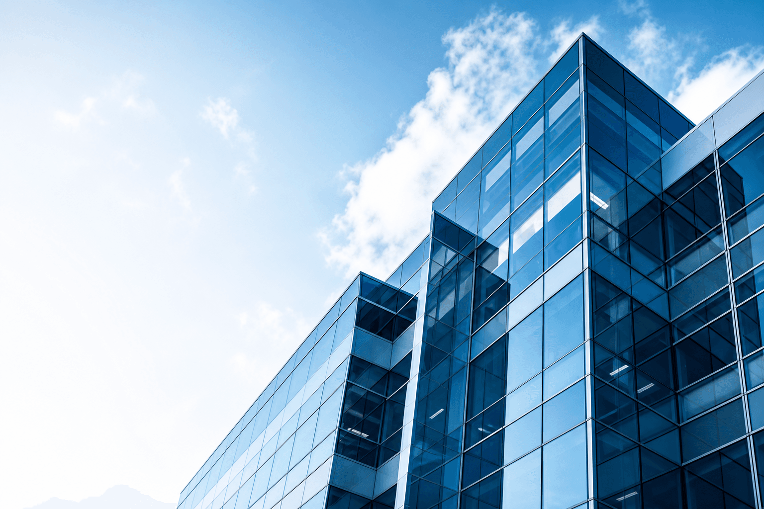 Modern glass office building representing Primex technology solutions